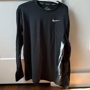 Nike. Men’s, DRI-FIT, black shirt. Pockets on sides w/ zippers.